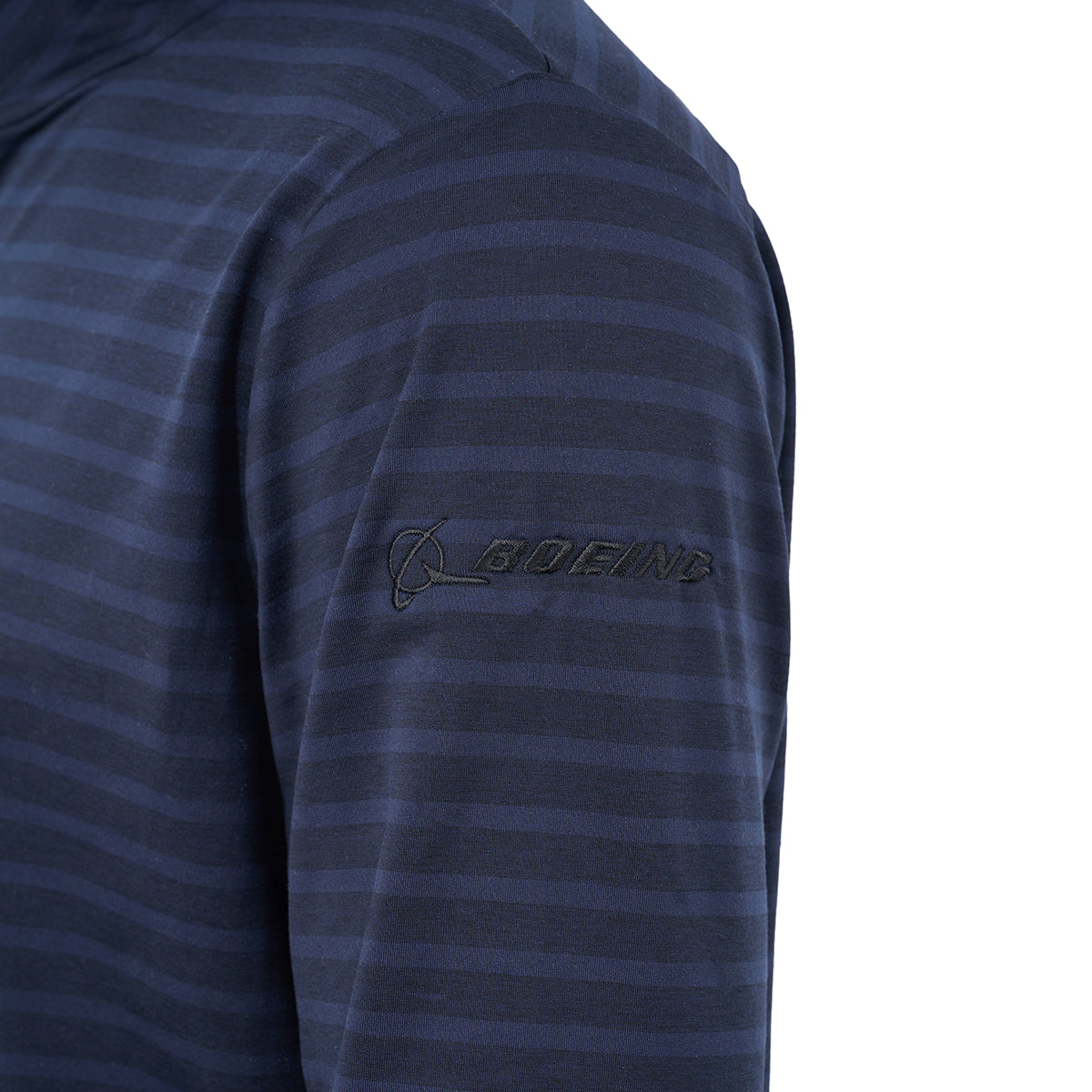 Close-up of a person's arm in the Glyder Boeing Men’s Tahoe Quarter-Zip by BOEING, featuring navy blue, long sleeves, stripes, AIRFLEX fabric, and a black Boeing logo on the upper sleeve. The background is plain white.
