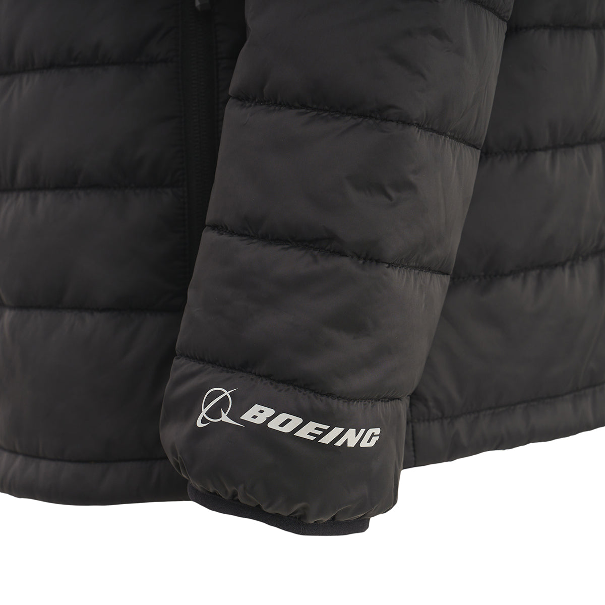 Close-up of the sleeve on the Boeing Men's Tri-Color Hooded Puffer Jacket by BOEING, showing the white logo and name printed near the cuff.