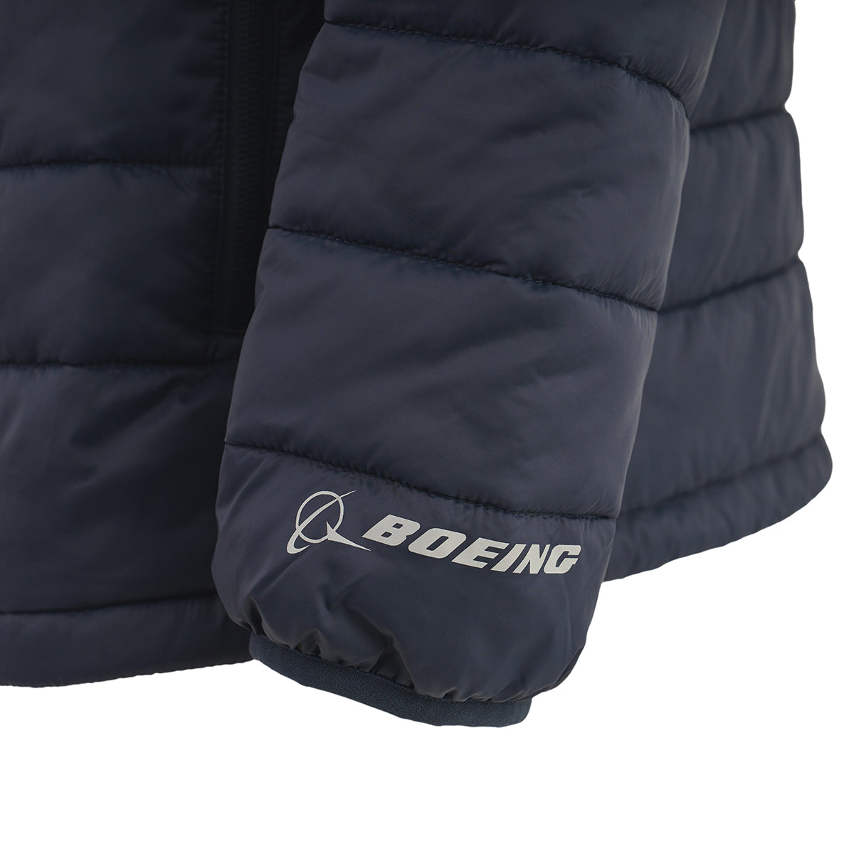 Close-up of the sleeve on the BOEING Men's Tri-Color Hooded Puffer Jacket in navy blue, featuring the white logo and name near the wrist. This water-resistant jacket keeps you warm and stylish.