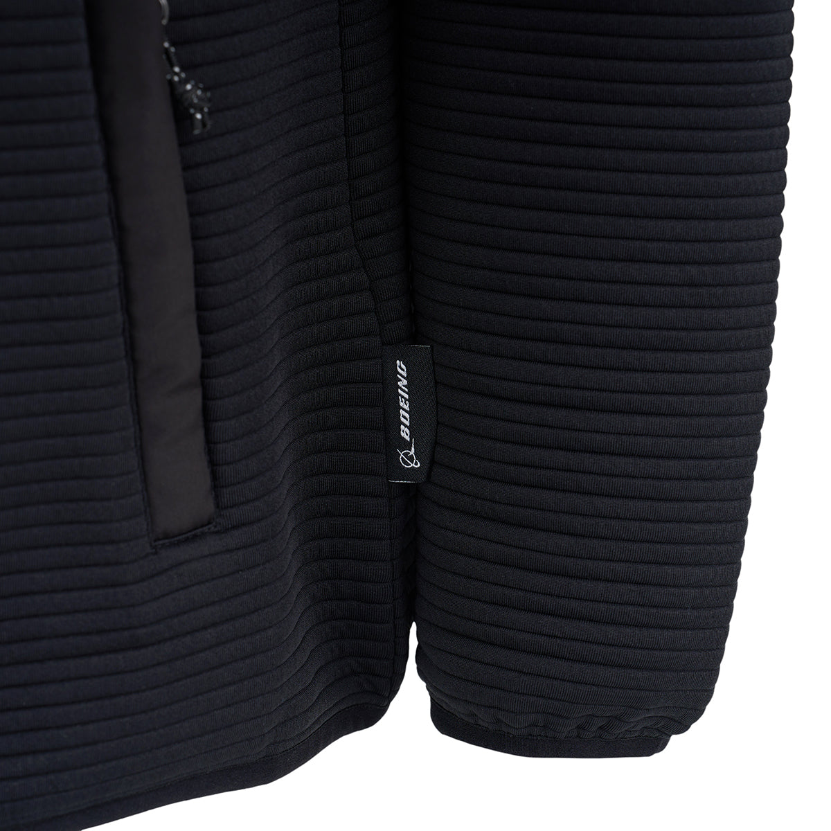 Close-up of the sleeve and side of the Boeing Men's Ottoman Quilted Knit Jacket, featuring a vertical zipper pocket and a small black fabric tag with BOEING in white text near the seam.