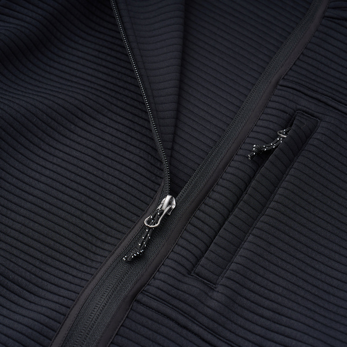 Close-up of the Boeing Men's Ottoman Quilted Knit Jacket in black, featuring ribbed quilting, a partially open zipper, and a zippered pocket on the right side.