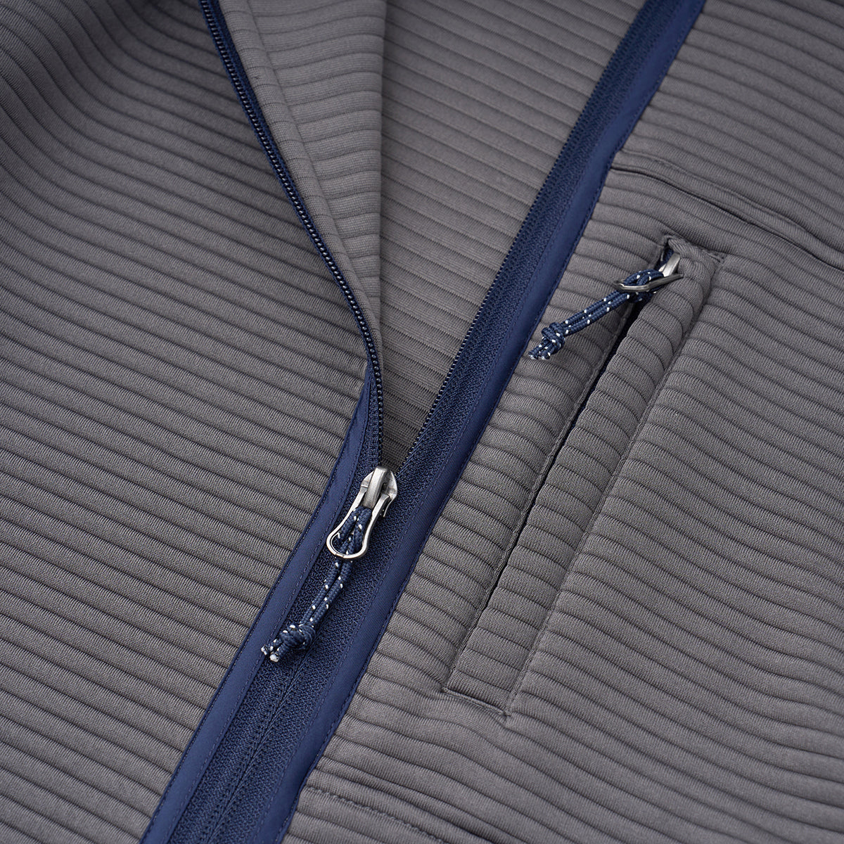Close-up of the Boeing Men's Ottoman Quilted Knit Jacket in gray, featuring ribbed fabric, a navy zipper, and a small zippered chest pocket, highlighting the jacket's insulated style by Boeing.