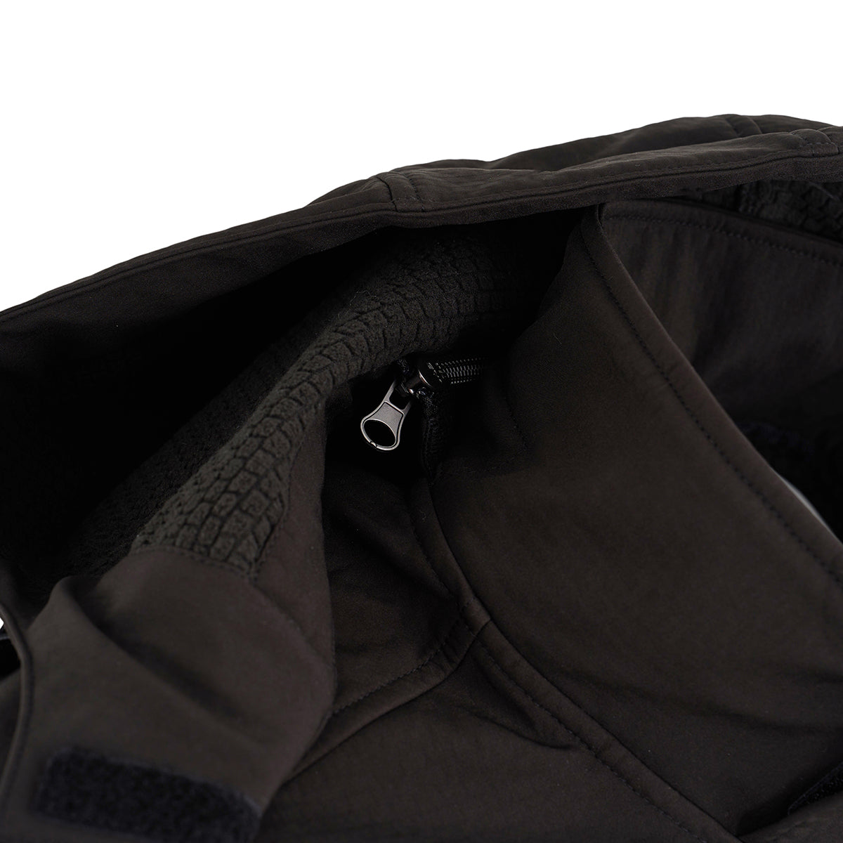 Close-up of the Boeing Men's Softshell Brick Jacket by BOEING, highlighting the zipper, inner lining details, and textured recycled shell fabric around the zipper.