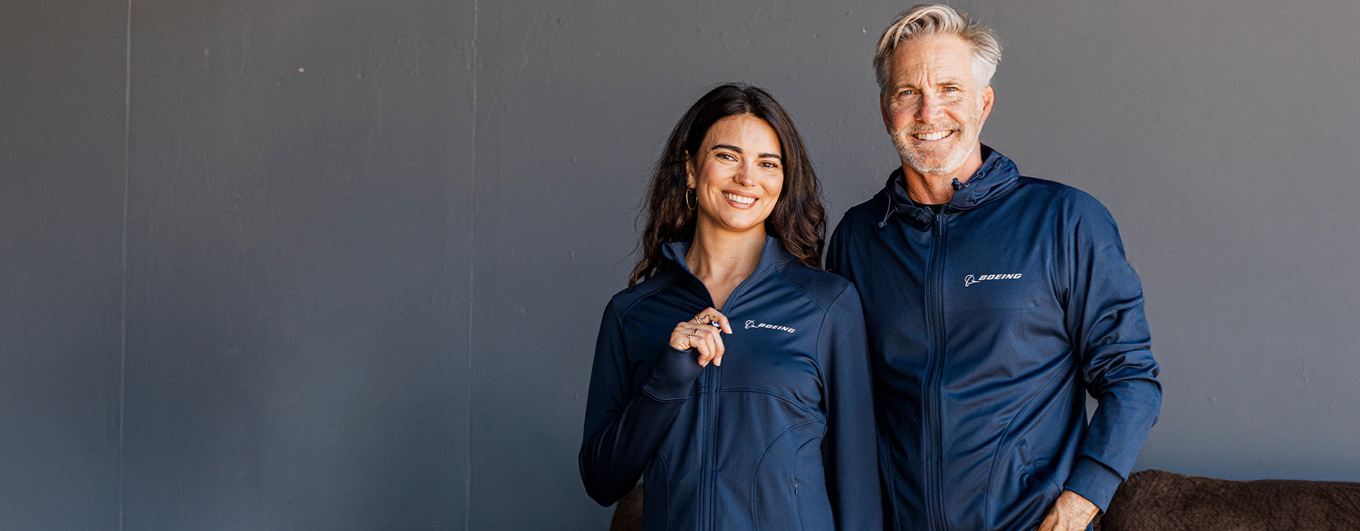Man and woman wearing new Boeing Signature full-zips in navy blue.