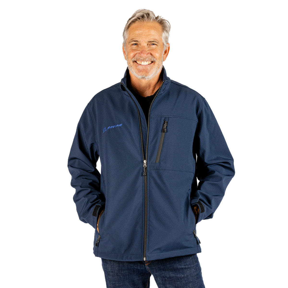 A smiling man wears a navy blue Boeing Unisex Softshell Stretch Jacket with a vertical zippered pocket.