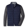 The Peter Millar Boeing Men's Hybrid Fleece Jacket by BOEING features a navy quilted zip front, gray contrast sleeves, a collar, and a subtle logo on the left chest for a refined look.