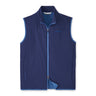 The Peter Millar Boeing Men’s Ridge Vest by BOEING is a sleeveless, zip-up navy blue vest with light blue lining and trim, a small chest logo, and side pocket zippers. This lightweight insulated vest is shown on a white background.