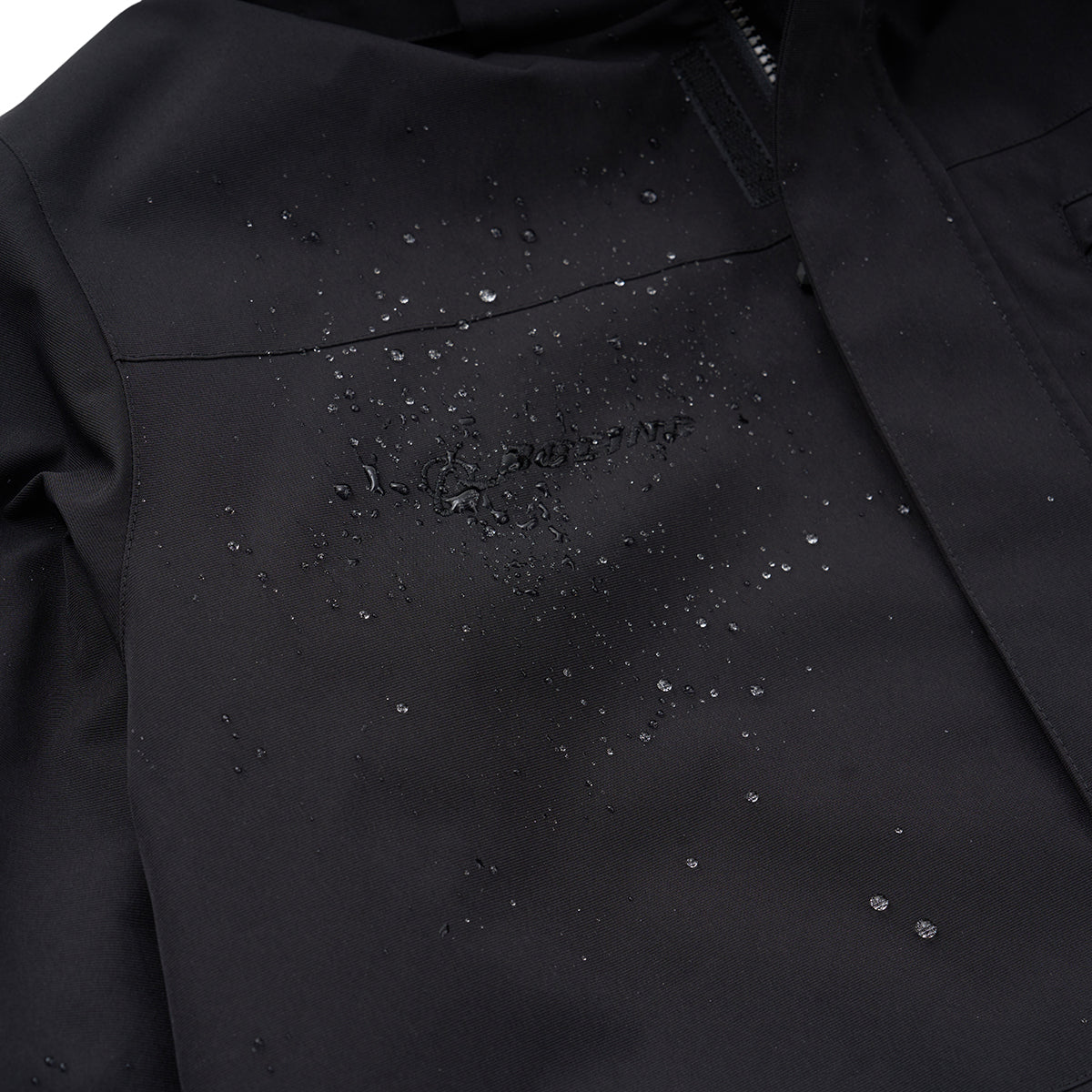 A close-up of the BOEING Men's 3-in-1 Systems Jacket in black, featuring water droplets on its water-resistant surface, a subtle embossed Boeing logo, and a visible zipper for superior weather protection.