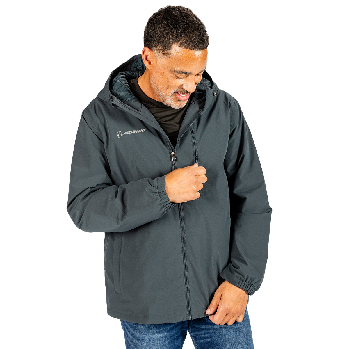 A man wears a dark gray Boeing Unisex Insulated Waterproof Rain Jacket featuring a chest pocket and a reflective Boeing logo on the right side of the chest.