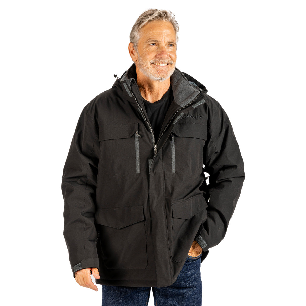 A smiling man wearing a black hooded Boeing Men’s Workman Jacket with multiple front pockets.