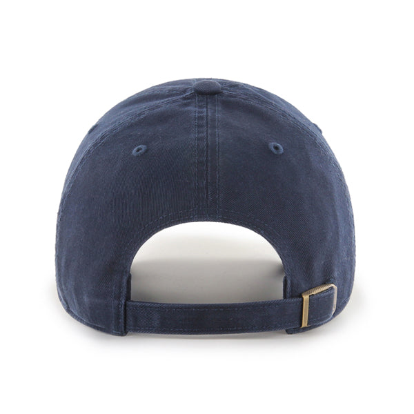 The 47 Boeing Signature Logo Clean Up Hat from The Boeing Store is shown in navy blue, highlighting its adjustable back strap with a brass buckle and stitched ventilation eyelets. The soft cotton twill fabric has a slightly worn appearance.