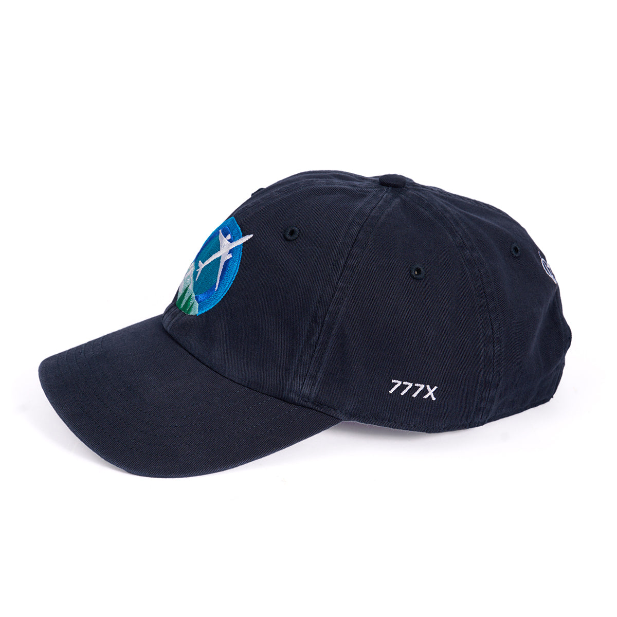 Introducing the Boeing 777X Skyward Hat: A navy baseball cap with an embroidered airplane over a green and blue backdrop. Featuring 777X stitched in white on the side, this cap includes an adjustable backstrap for a perfect fit.