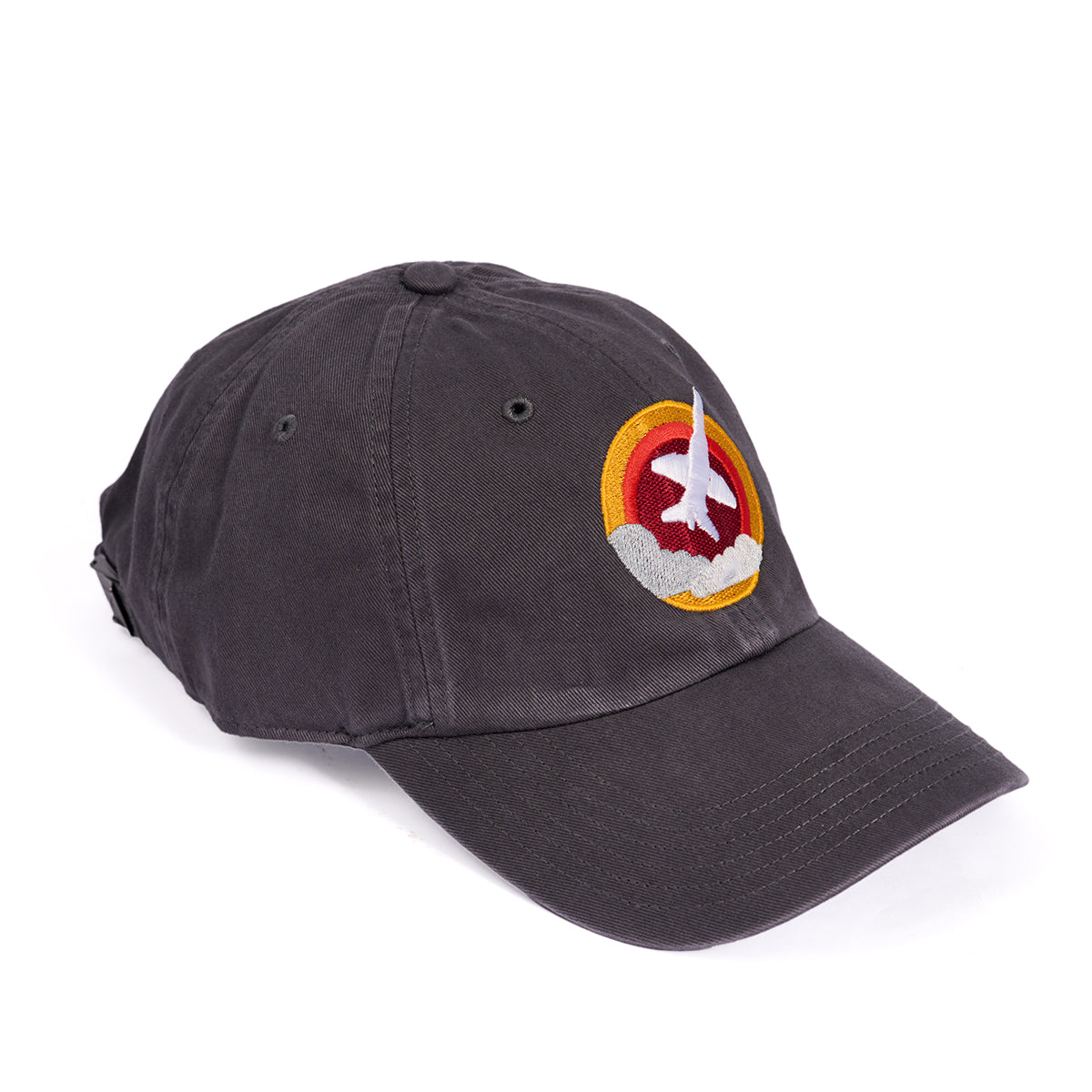 The Boeing T-7A Red Hawk Skyward Hat is a black cap featuring an embroidered patch of the aircraft soaring against a red and yellow circular logo. It includes an adjustable cloth backstrap for a perfect fit.