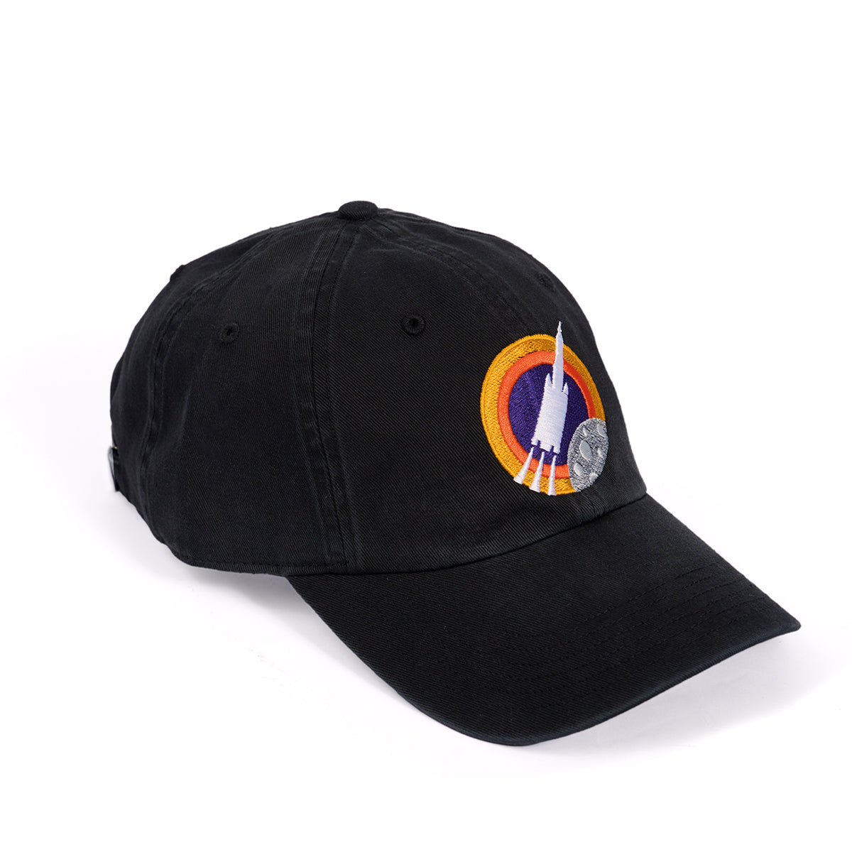 The Boeing Space Launch System Skyward Hat is a black baseball cap featuring a colorful embroidered patch of a rocket and planetary design. It includes an adjustable cloth backstrap for comfort, making it ideal for space enthusiasts.