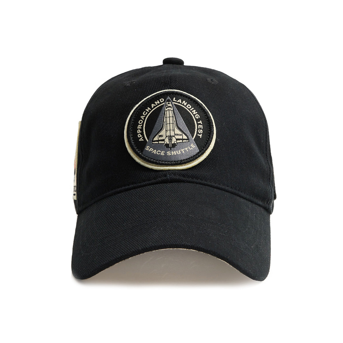 The Red Canoe NASA ALT Shuttle Hat by Boeing features a black cap with a patch displaying a space shuttle and the words Approach and Landing Test Space Shuttle. It has a circular patch with a yellow border, perfect for any space enthusiast celebrating an iconic mission.