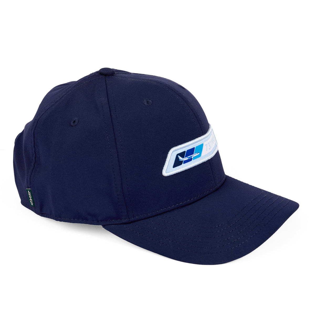 The Boeing 737 MAX Velocity Unisex Hat by Boeing is a navy blue moisture-wicking cap with a light blue rectangular patch featuring a geometric design and small text on the front. It has a curved brim, adjustable Velcro closure, and visible stitching for enhanced style and comfort.