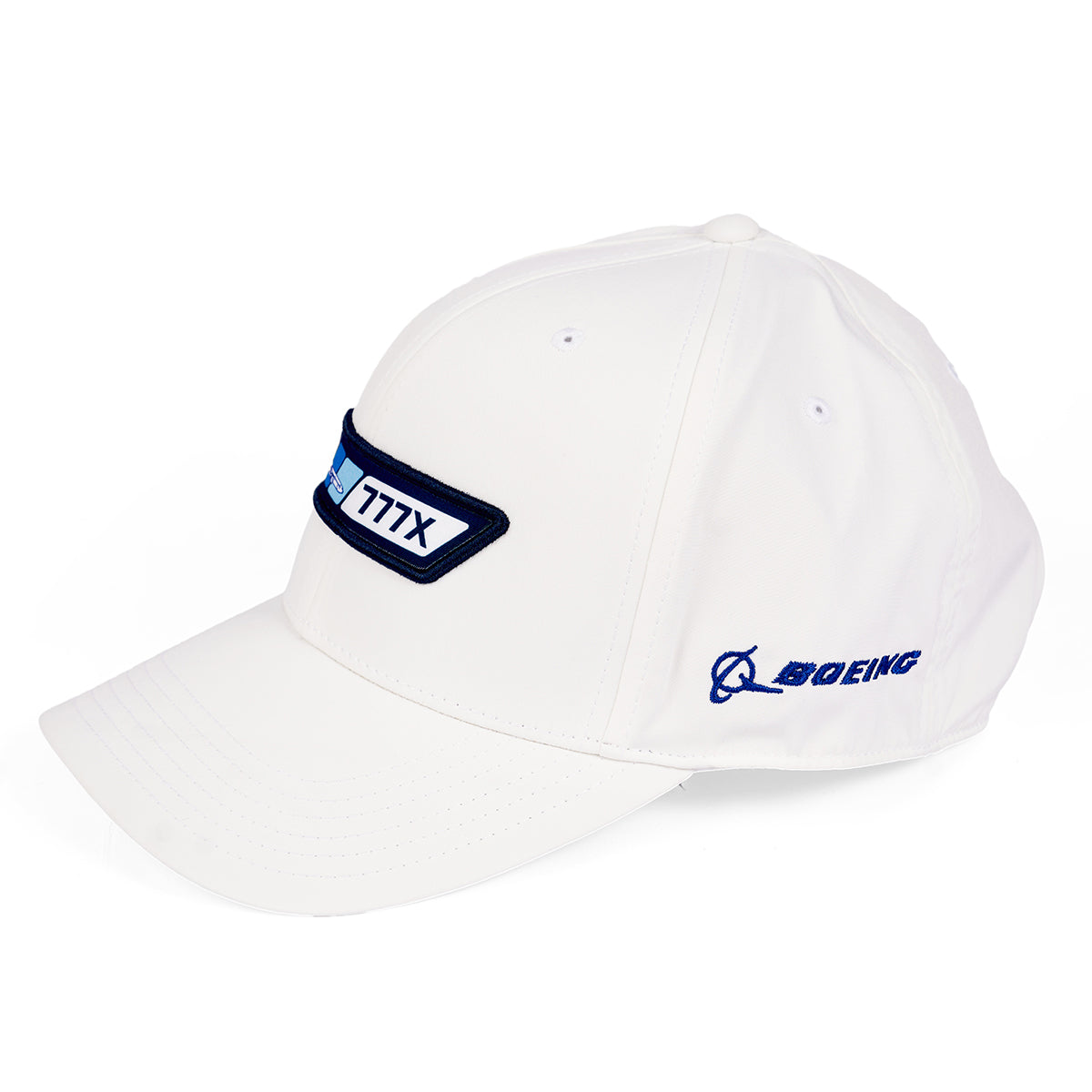 The Boeing 777X Velocity Unisex Hat, a white cap with a blue Boeing 777X patch, features the iconic Boeing logo on the side. Designed for style and functionality, it includes an adjustable velcro closure for a perfect fit.