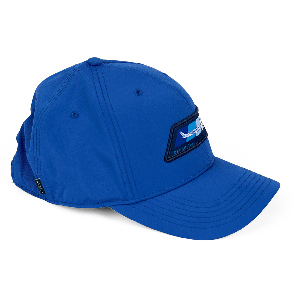 The Boeing 787 Dreamliner Velocity Unisex Hat is a blue, moisture-wicking baseball cap with a curved brim, featuring an aircraft logo patch and Boeing 787 Dreamliner text. Detailed stitching accents the panels, and it has an adjustable velcro closure for a perfect fit.