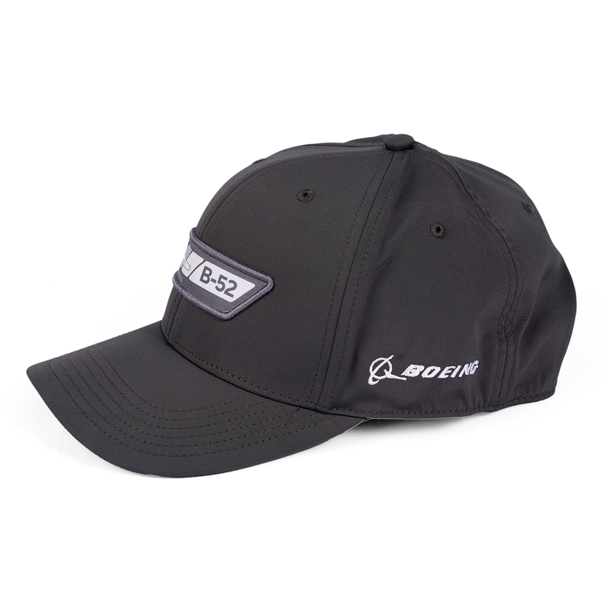 The Boeing B-52 Velocity Unisex Hat is a moisture-wicking black baseball cap featuring an embroidered B-52 patch on the front. The Boeing logo graces the side, and its displayed on a white background, combining style and functionality.