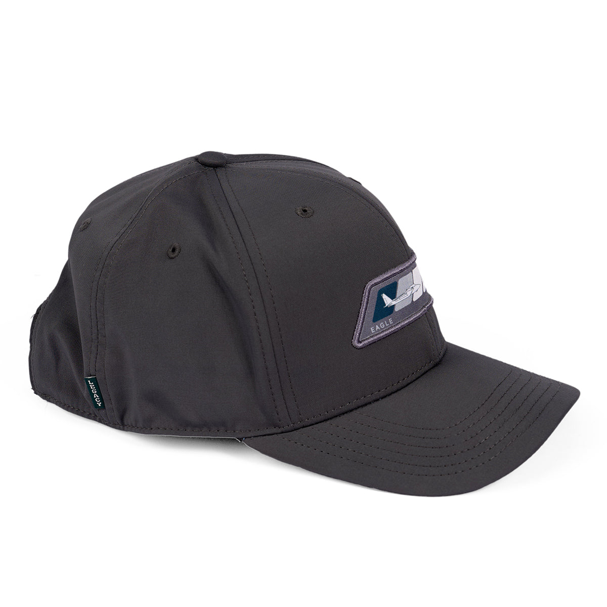 The Boeing F-15 Eagle Velocity Unisex Hat is a dark gray cap with an eagle-design patch, featuring moisture-wicking material, a curved brim with visible stitching, an adjustable Velcro closure, and a small side tag.