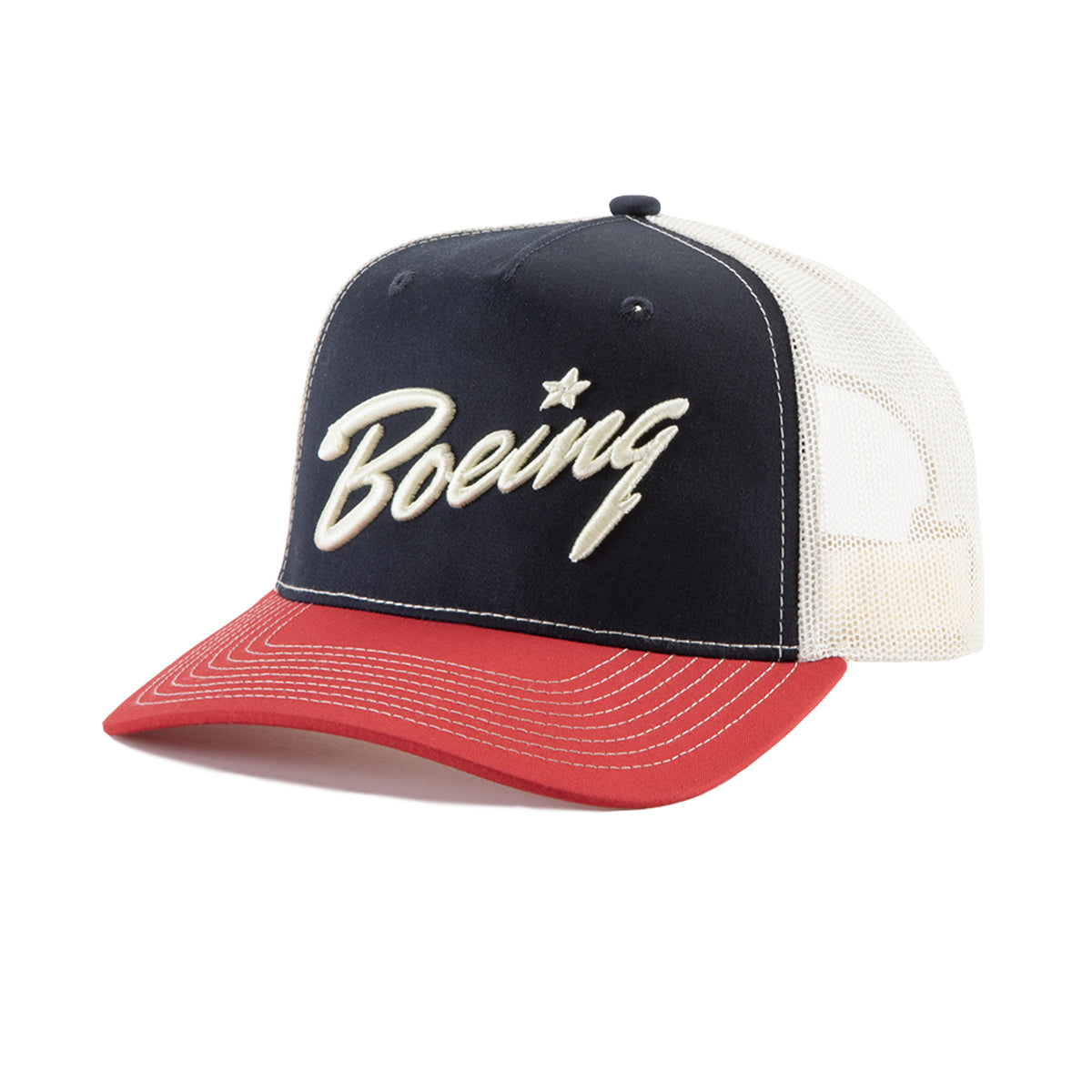 The BOEING Richardson Boeing Script Logo Trucker Hat has a navy front with cream embroidery, cream mesh back, and red bill with white stitching. It features a Softsnap structure and adjustable snapback for comfort and the perfect fit.