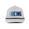The Richardson Boeing Golf Hat by BOEING is a stylish white performance cap with "BOEING" embroidered in white, light blue, and dark blue on the front, plus a dark rope detail across the brim—ideal for golf.