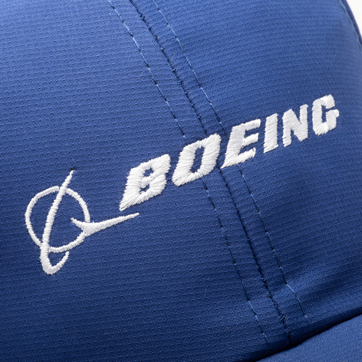 Close-up of the Boeing Signature Logo Performance Hat by BOEING, showcasing its blue design with a white embroidered Boeing logo and name on the front for a classic look.