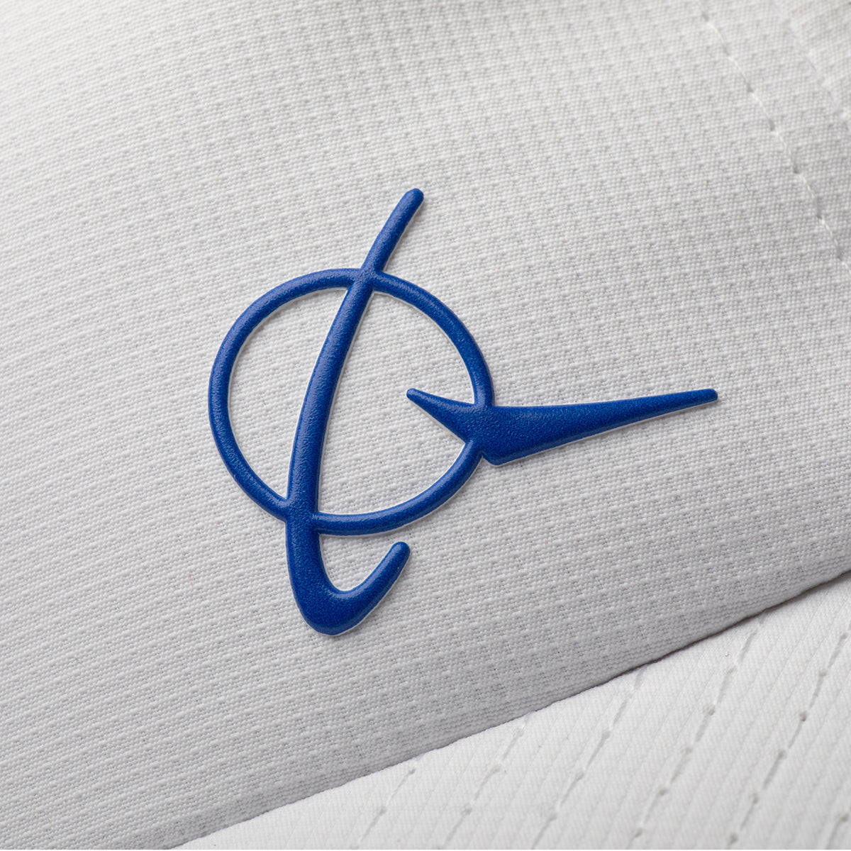 Close-up of the blue BOEING Signature Logo on white textured fabric with a stylized ring and swoosh—ideal for the Boeing Signature Logo Performance Hat.