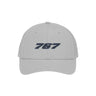 The BOEING 767 Series Hat is a light gray cap featuring the bold, dark “767” number on the front. Designed for breathability, it includes side ventilation holes, visible stitching along the brim, and a snapback closure for an adjustable fit.