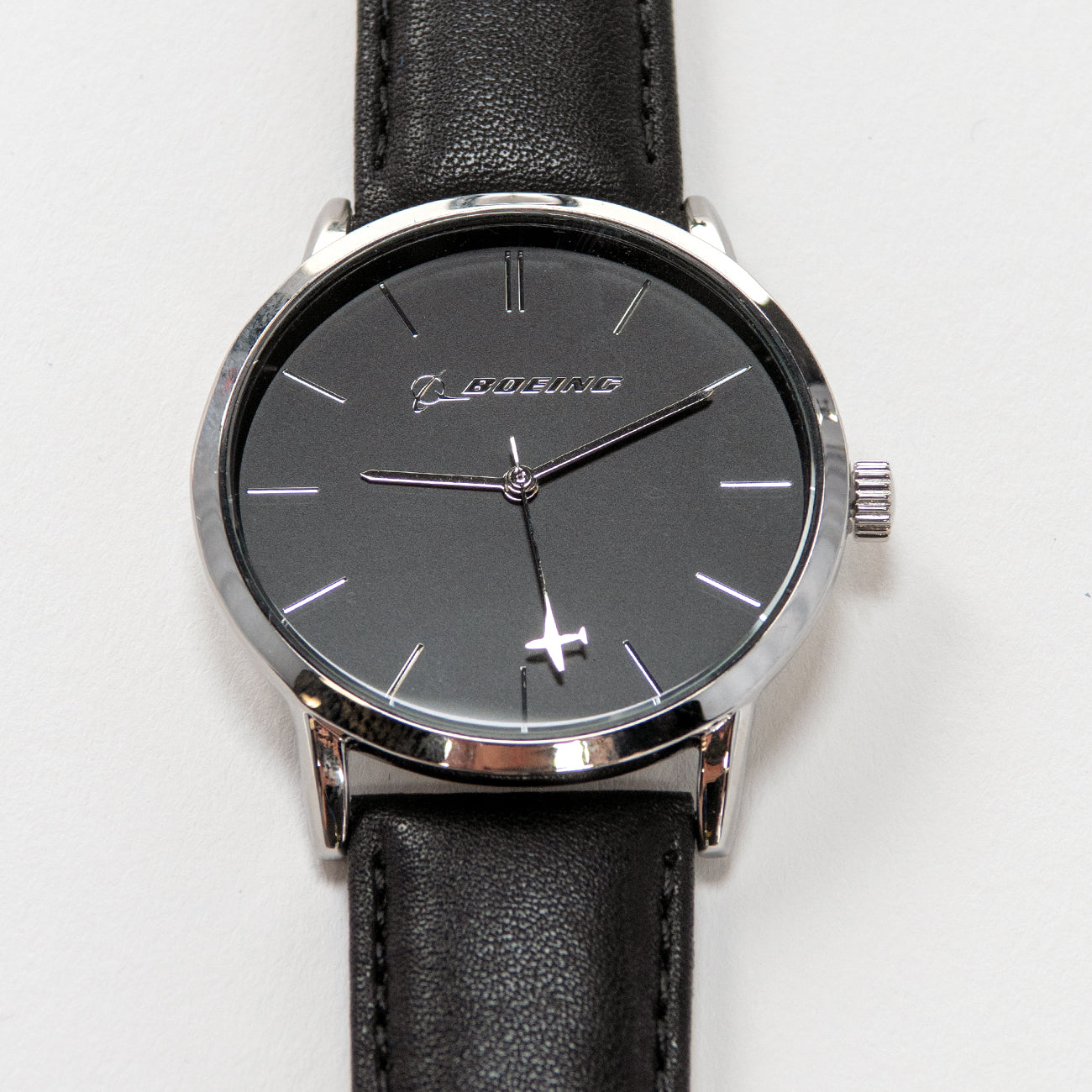The Boeing Silver Rotating Airplane Watch is a sleek mens timepiece with a black face, silver hour markers and hands, Boeing on the dial, and comes with a black leather strap and silver case for timeless elegance.