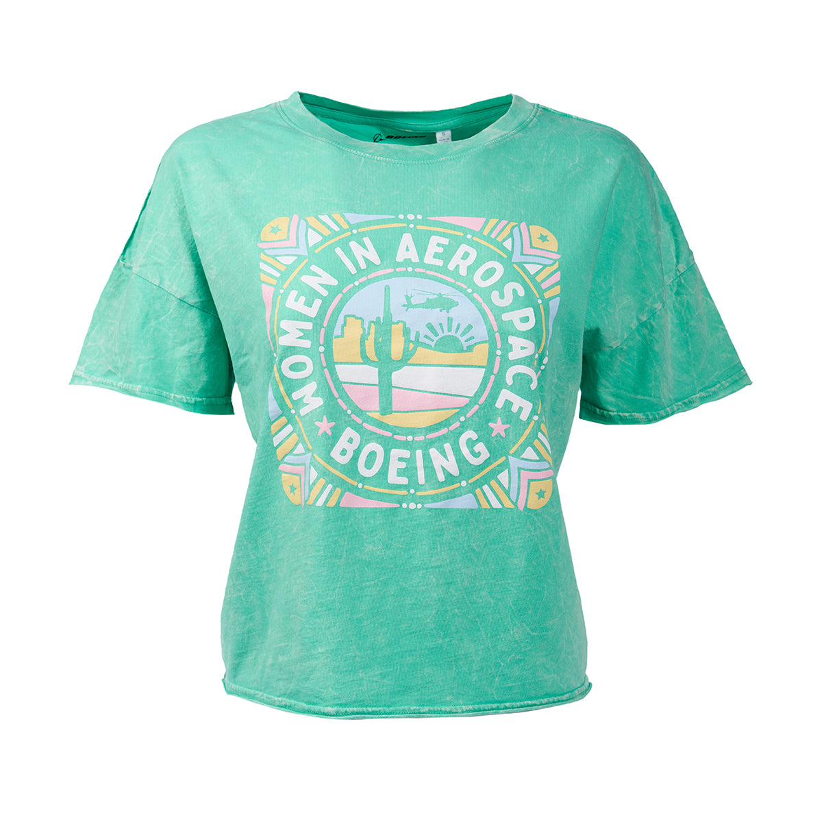 The Boeing Women In Aerospace Defense Womens T-Shirt by Boeing features a graphic of “Women in Aerospace” with a desert landscape, cacti, sun, and mountains—ideal for celebrating women in the aerospace industry.