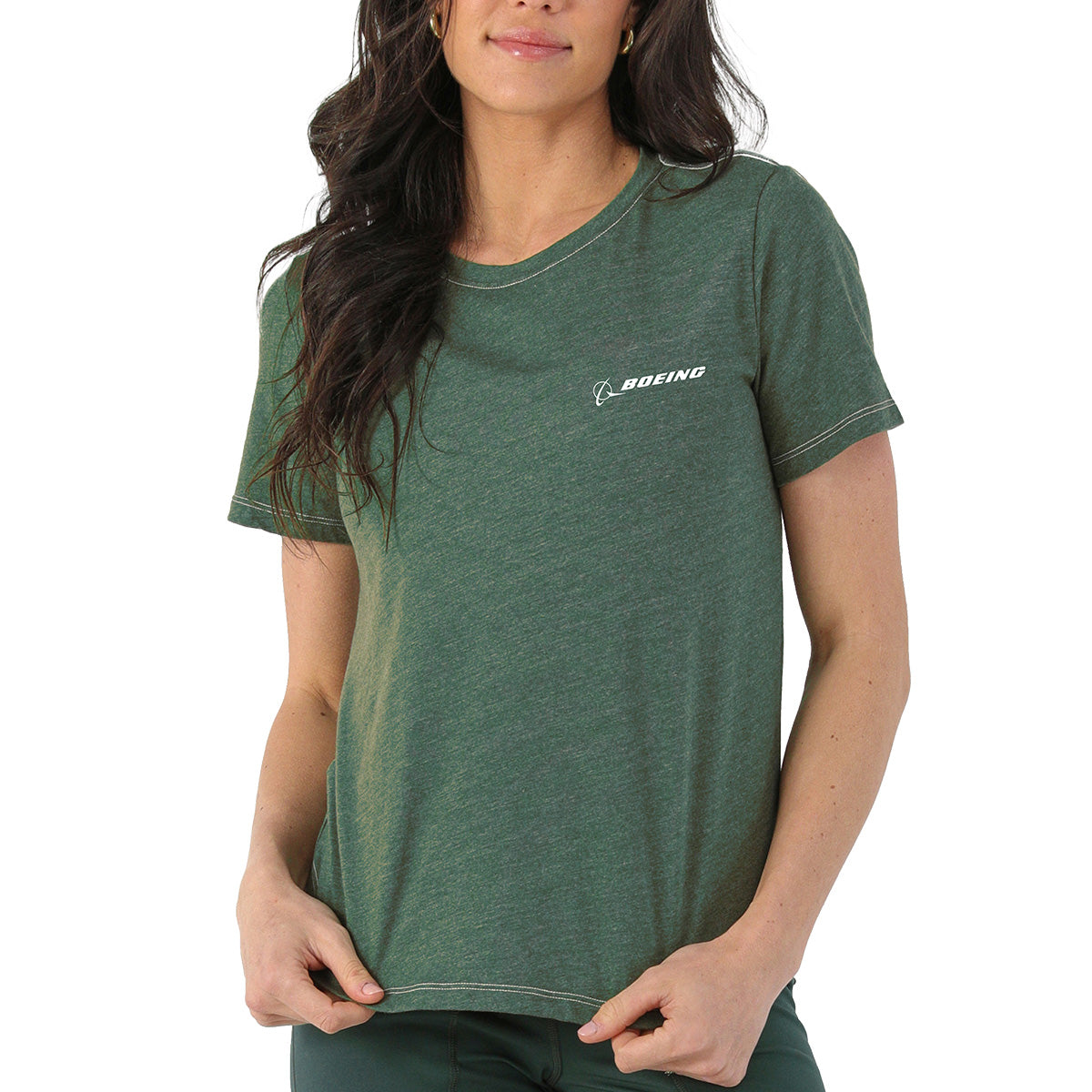 A woman wears the Glyder Boeing Women’s No Harm T-Shirt—a green, soft organic cotton crew-neck by BOEING, with the brand's name and logo in white on the left chest—standing against a plain white background.
