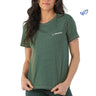 A woman wears the Glyder Boeing Women’s No Harm T-Shirt—a green, soft organic cotton crew-neck by BOEING, with the brand's name and logo in white on the left chest—standing against a plain white background.