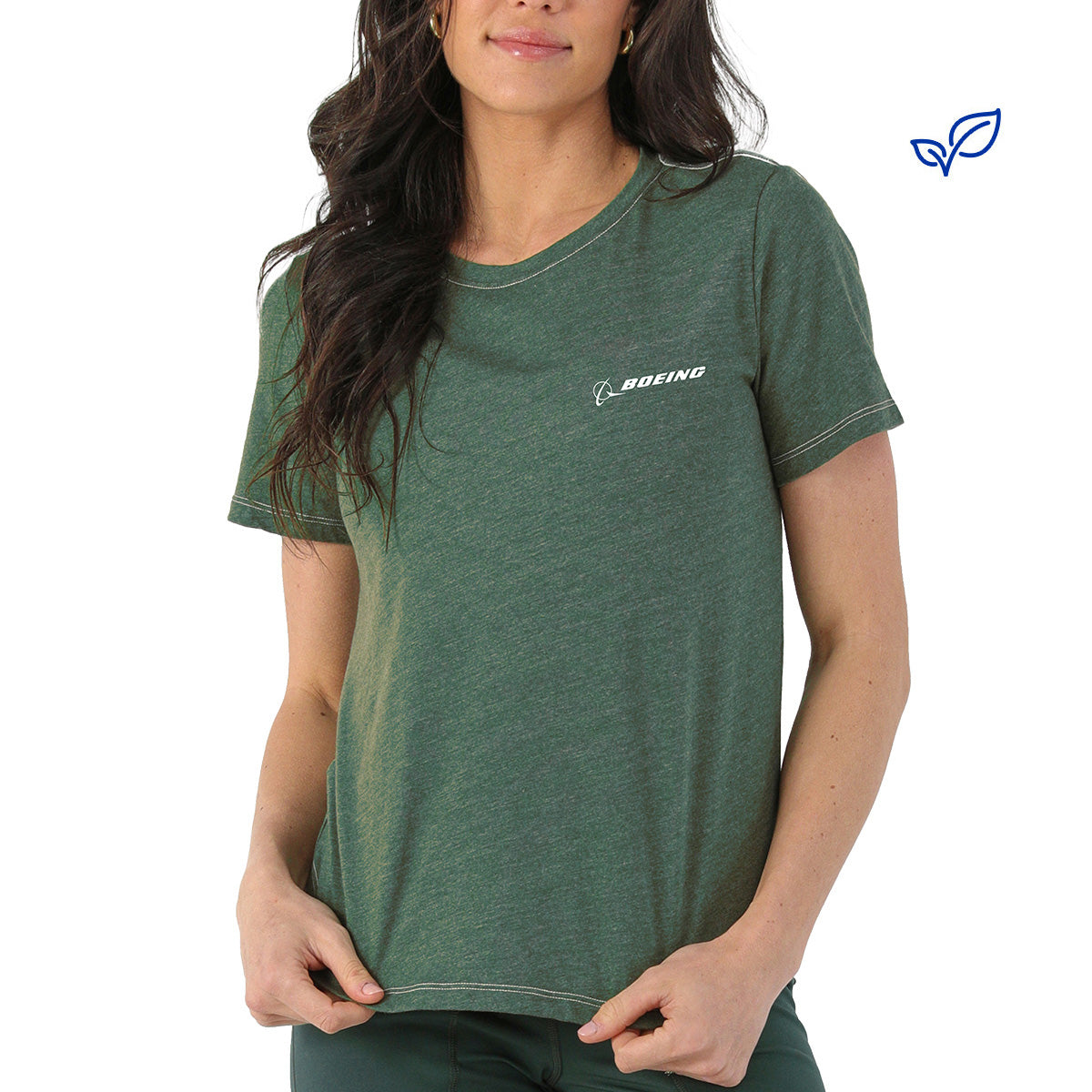 A woman wears the Glyder Boeing Women’s No Harm T-Shirt—a green, soft organic cotton crew-neck by BOEING, with the brand's name and logo in white on the left chest—standing against a plain white background.