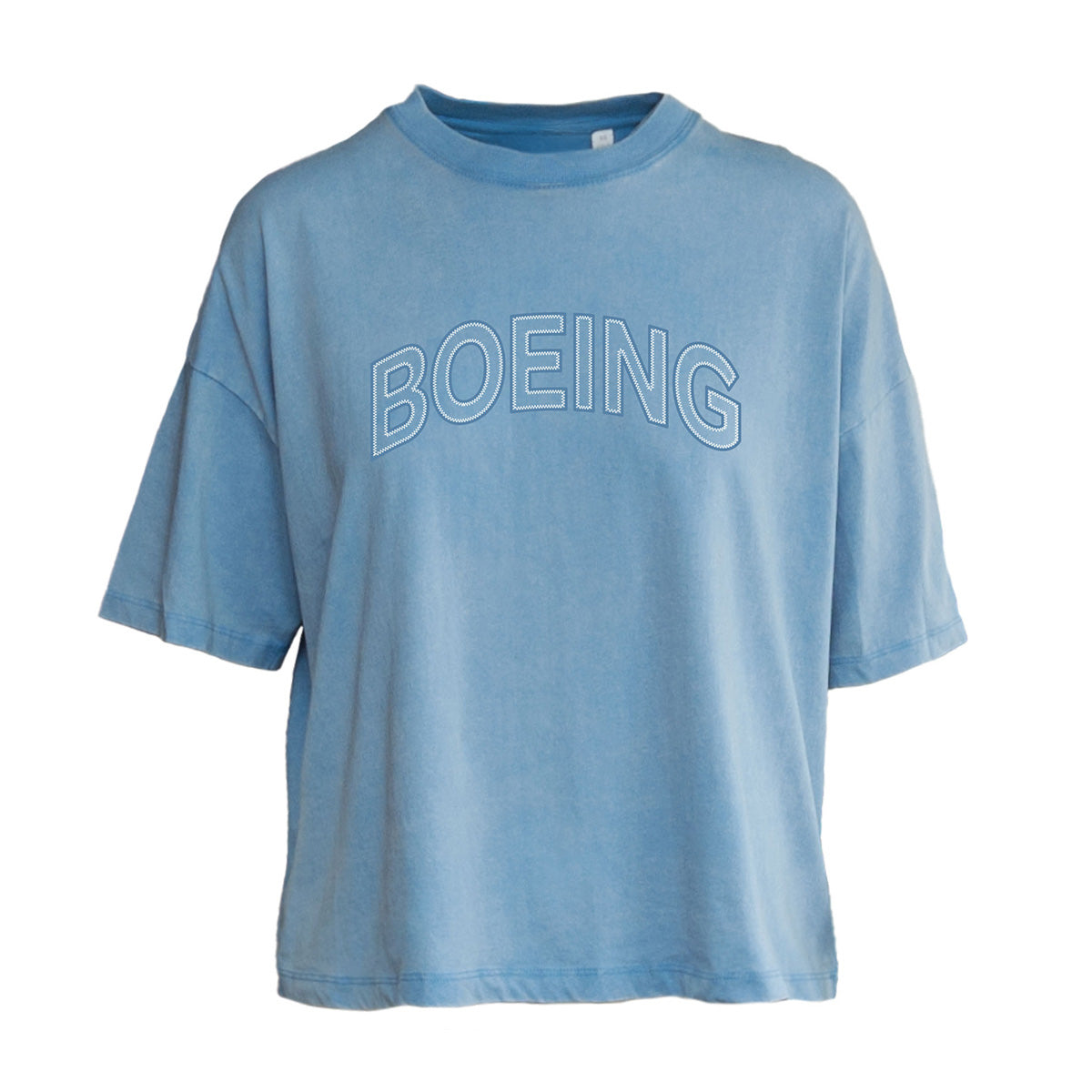 The Boeing Women's Boardwalk T-Shirt by BOEING features soft light blue cotton jersey, a relaxed oversized fit, short sleeves, and large white outlined lettering across the chest for comfortable, effortless style.