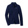 The Peter Millar Boeing Women’s Lumi-Knit Full-Zip by BOEING is a navy blue performance jacket featuring a stand collar and zippered pockets, with a small white Boeing logo on the left chest. Designed with four-way stretch for comfort and mobility, the jacket is displayed laid flat on a white background.