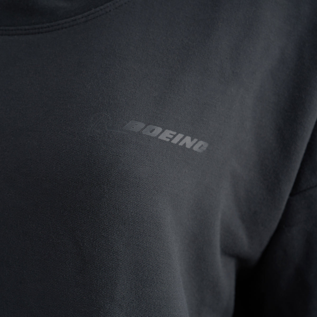 Close-up of the Glyder Boeing Women’s Lounge Sweater by BOEING, made with soft ISOSOF™ fabric and featuring subtle gray BOEING text printed near the chest.