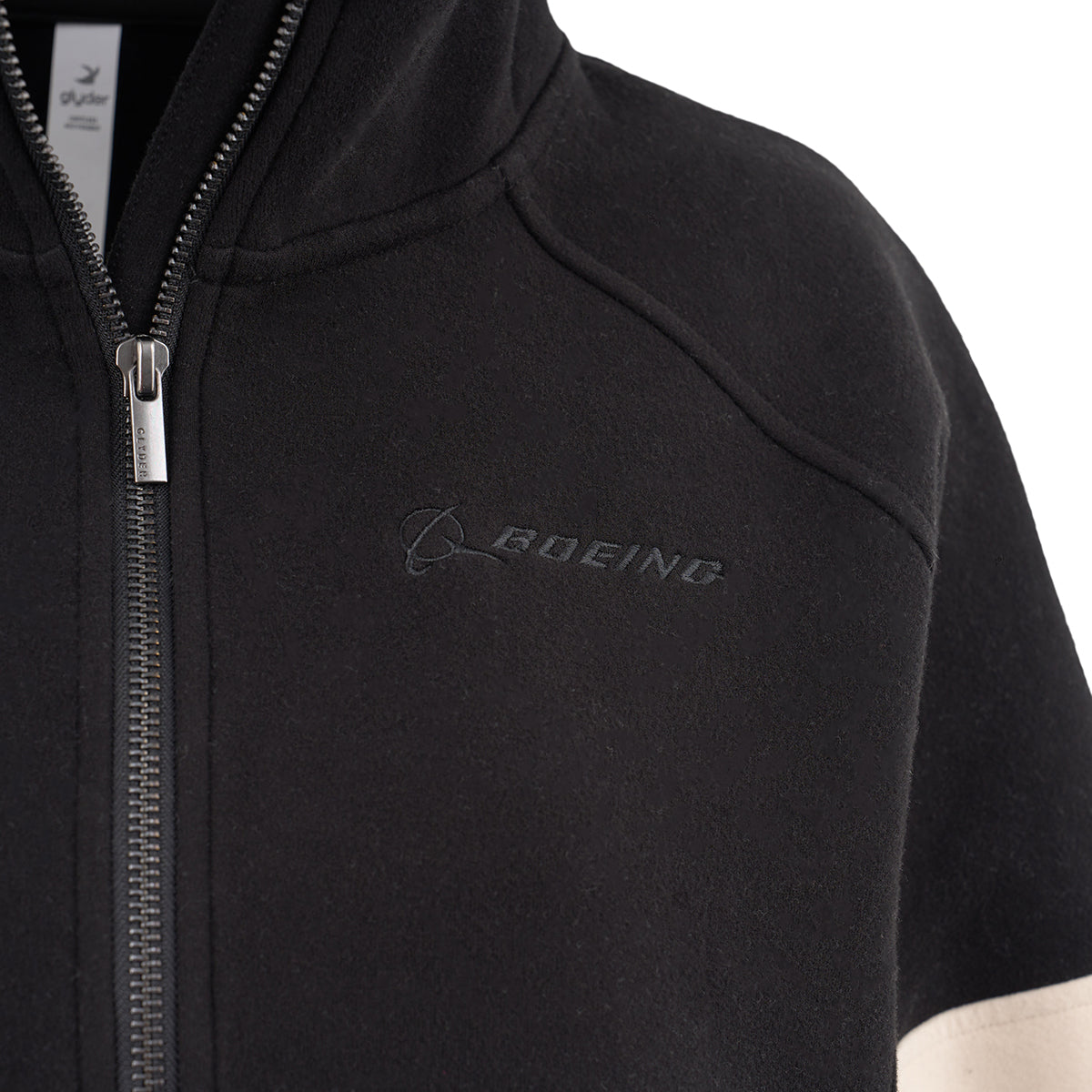 Close-up of the Glyder Boeing Women’s Prodigious Scuba Quarter-Zip by BOEING, featuring a black scuba-style design, embroidered logo on the chest, partially open silver zipper, soft fabric, and part of a light sleeve visible on the right.