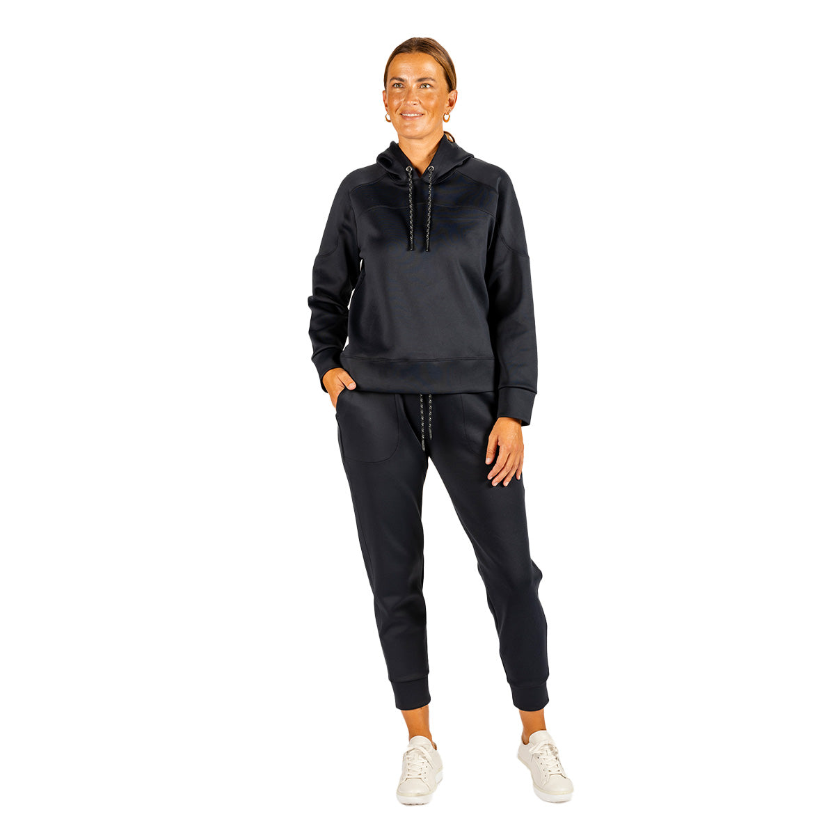 A person wearing a Boeing Women’s Sueded Lush Hoodie and matching jogger pants with white sneakers.