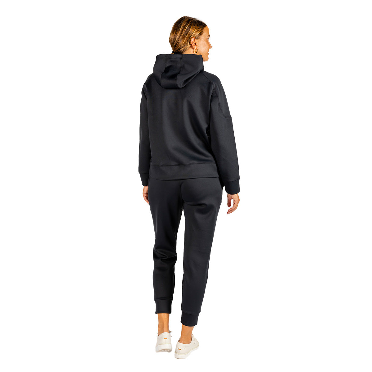 Back view of a person wearing a black Boeing Women’s Sueded Lush Hoodie and matching black jogger pants.