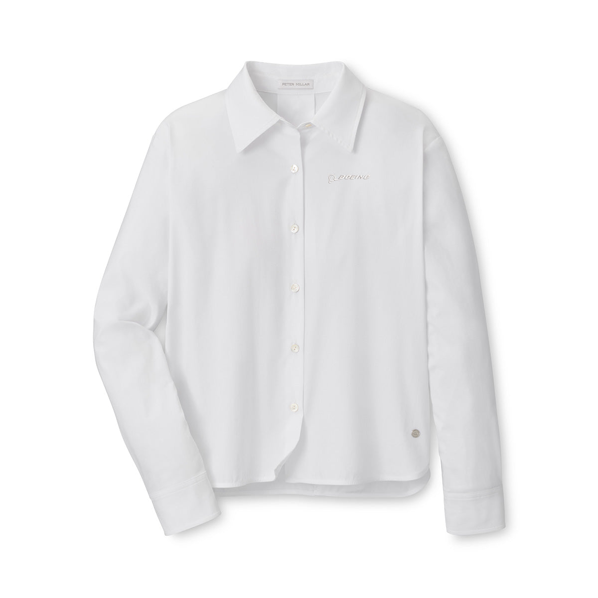 The Peter Millar Boeing Women’s Sylvia Button-Up Shirt by BOEING is a long-sleeve white Italian stretch cotton shirt, featuring a collar, embroidered text on the left chest, and a circular tag near the hem.