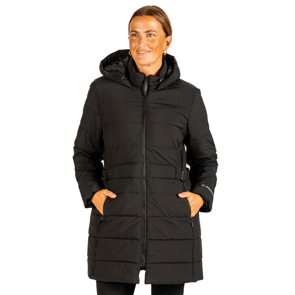 A woman wears a black, water-resistant Boeing Women’s 3/4 Length Puffer Jacket with a hood, zippered pockets, and a Boeing logo.