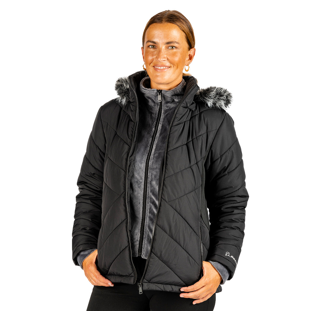 A woman wearing a black, water-resistant Boeing Women’s Hybrid Puffer Jacket with a faux-fur trimmed hood over a gray zippered fleece.