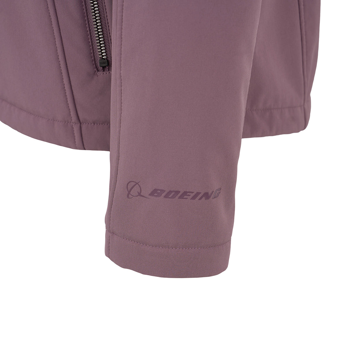 Close-up of the BOEING Women's Aeris Super-Softshell Jacket sleeve in mauve, crafted from recycled polyester with a zipper and the Boeing logo printed near the cuff.