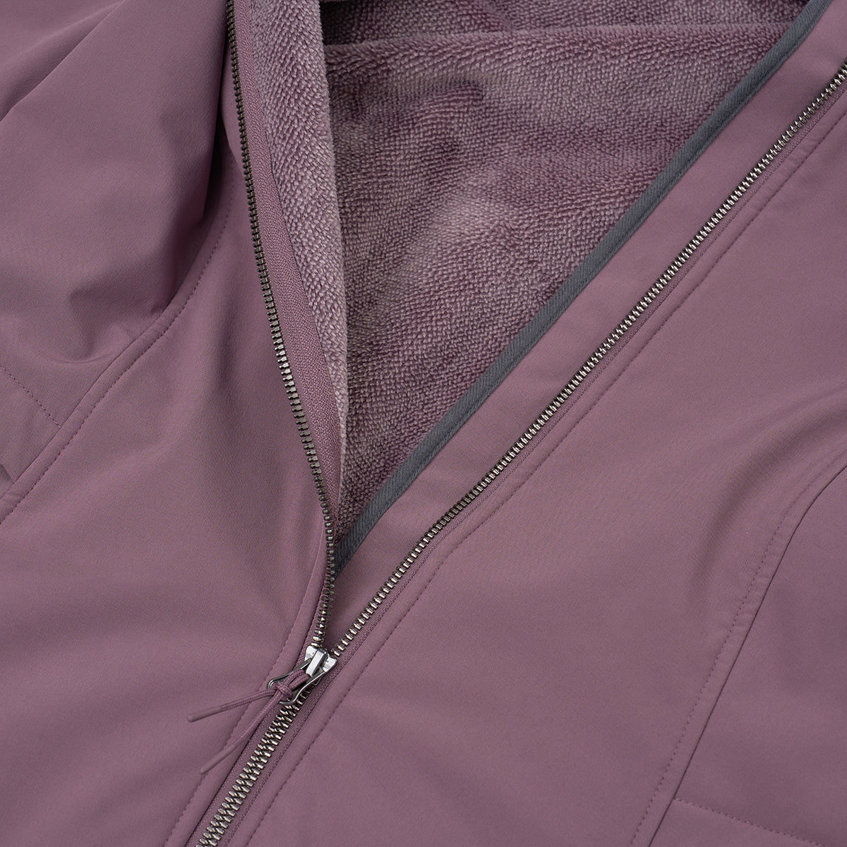 Close-up of the BOEING Women's Aeris Super-Softshell Jacket in mauve, featuring a partially open zipper that reveals its soft, textured fleece lining.
