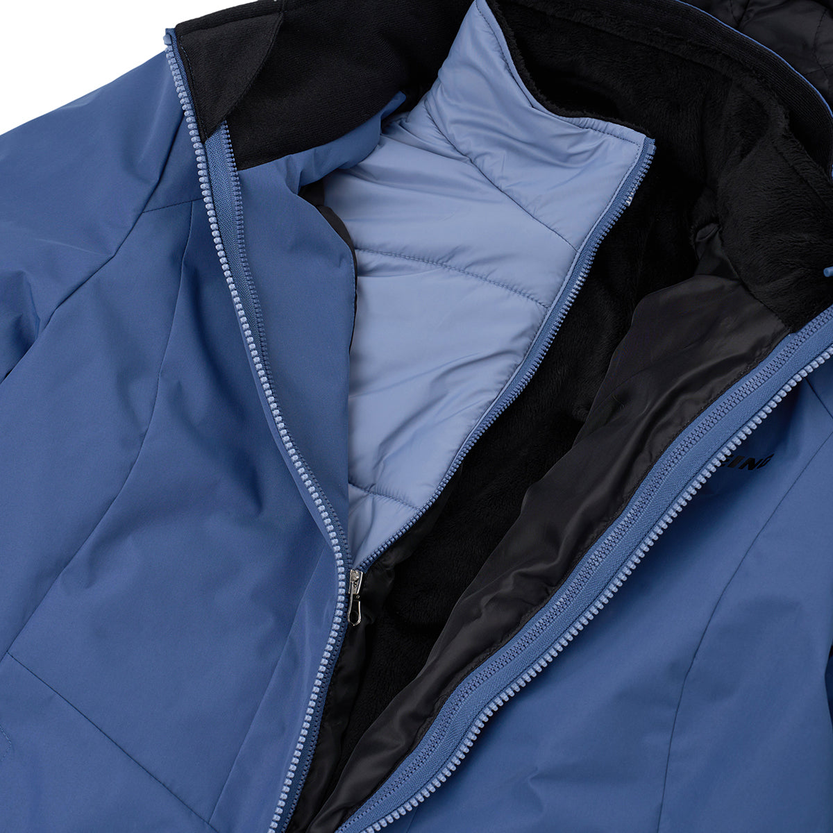A close-up of the Boeing Women's 3-in-1 Systems Jacket by BOEING, a blue quilted puffer with an unzipped front revealing black and light blue lining. Wind resistant, it features a high collar and insulated interior for warmth.
