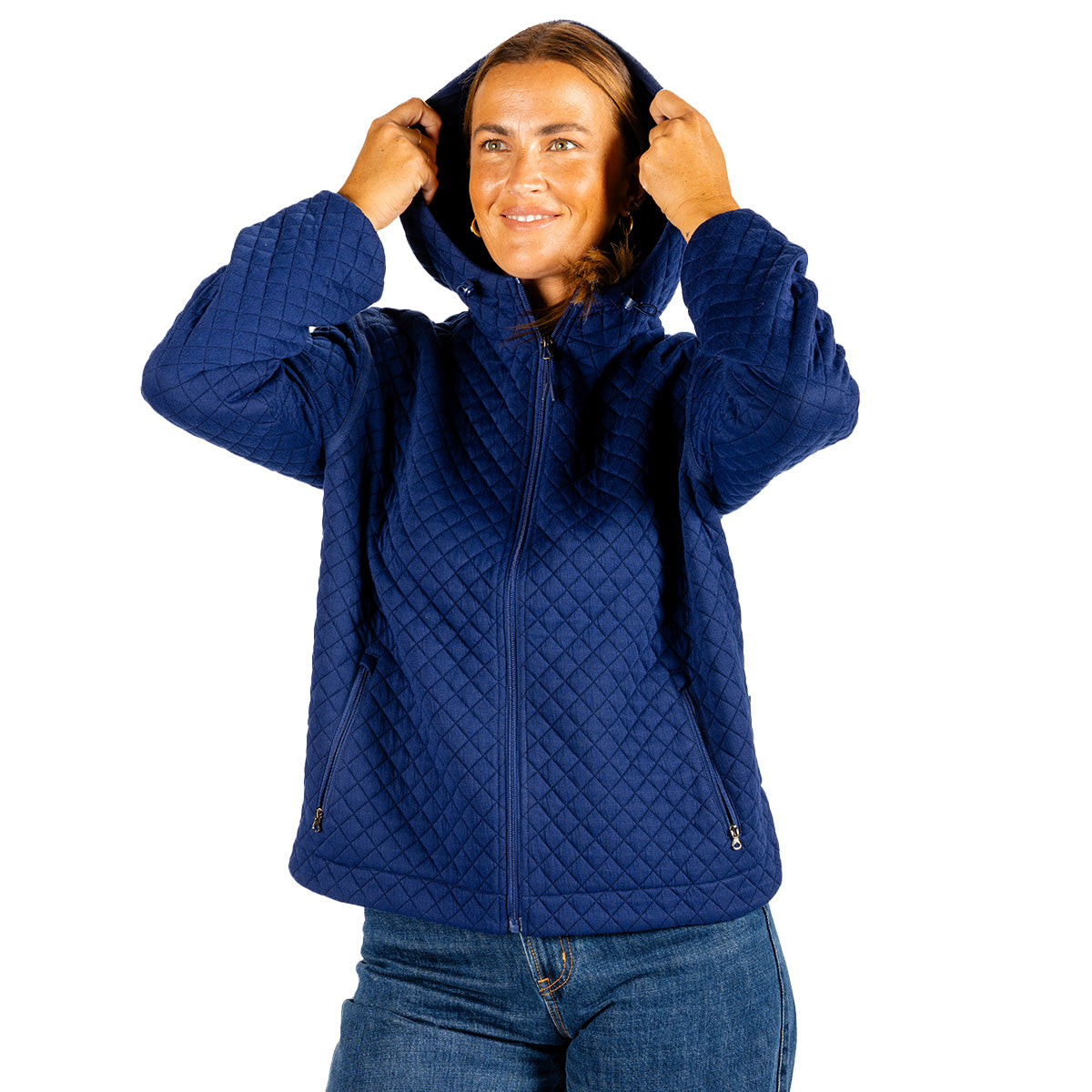 A woman wears a navy blue quilted Boeing Women’s Hooded Quilted Jacket with a hood and zippered pockets.