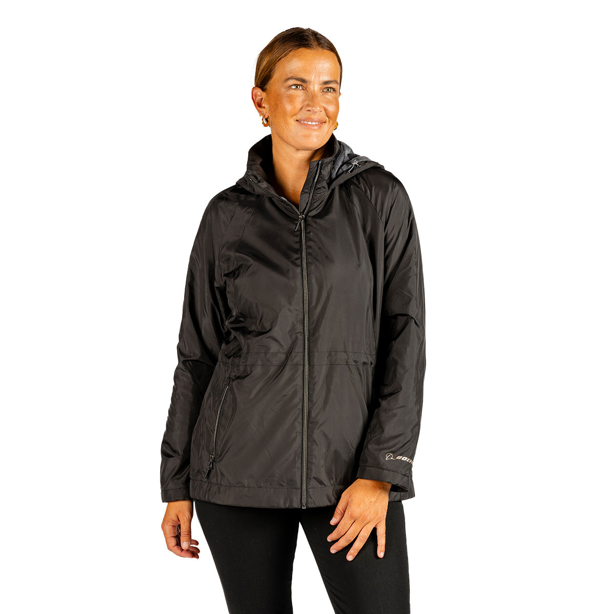 A woman wearing a black Boeing Women’s 3/4 Length Windshear Jacket, a three-quarter length hooded wind-resistant coat with a front zipper and zippered side pockets.