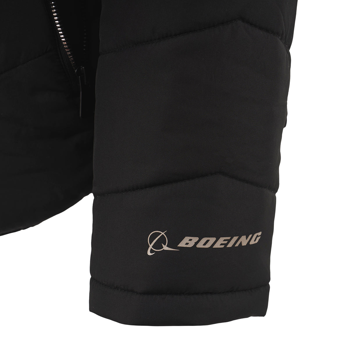 Close-up of a black Boeing Women's Quilted Butterpile Jacket sleeve with the white BOEING logo near the cuff, featuring wind-resistant fabric for comfort.