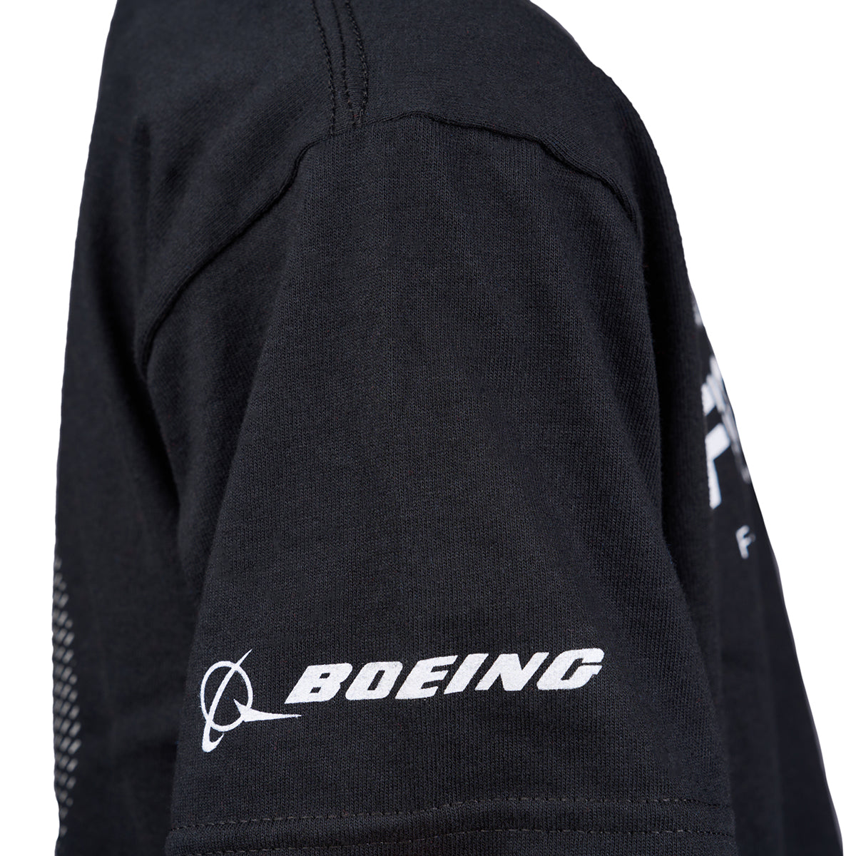 A side view of the Boeing Fighters F-15 Youth T-Shirt in black shows the white Boeing logo and sleeve text—a tribute to Air Dominance Fighters from Boeing St. Louis.